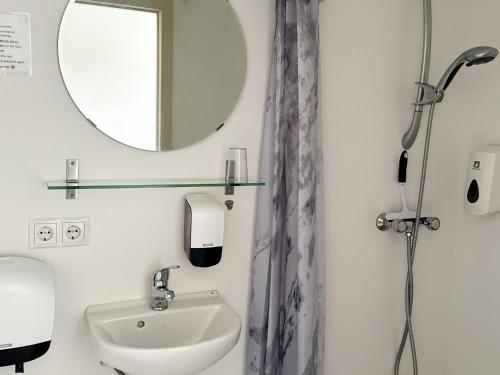 a bathroom with a sink and a mirror at Hotel Drangshlid in Skogar