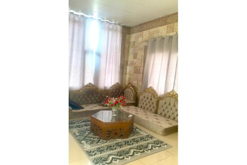 a living room with a couch and a table at OYO 157 Dream Barka Hotel in Barka