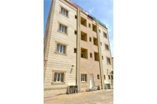 a large brick building with windows on the side at OYO 157 Dream Barka Hotel in Barka