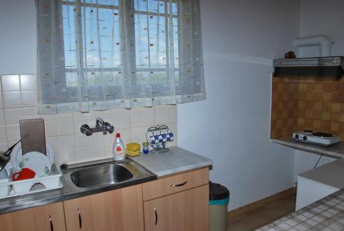 a kitchen with a sink and a counter top at Niriton Pension in Nydri