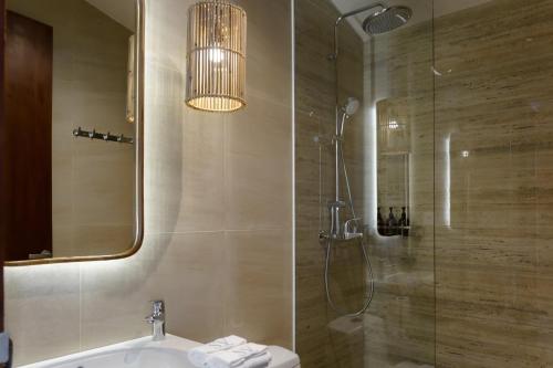 a bathroom with a shower and a sink and a toilet at Sunny Cuddles in Canggu