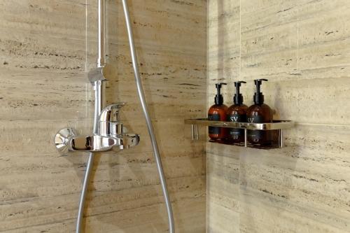 a bathroom with a shower with bottles of wine at Sunny Cuddles in Canggu