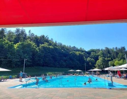 a large swimming pool with many people in it at Kuća za odmor Anita in Generalski Stol