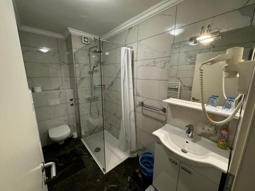 a bathroom with a shower and a sink at Gostišče pri Slavcu in Šentjernej