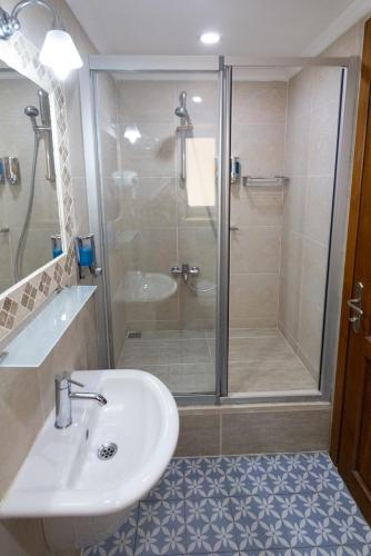 a bathroom with a shower and a sink and a toilet at Luna Kaş in Kas