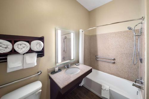 a bathroom with a sink and a tub and a shower at La Quinta by Wyndham Houma in Houma