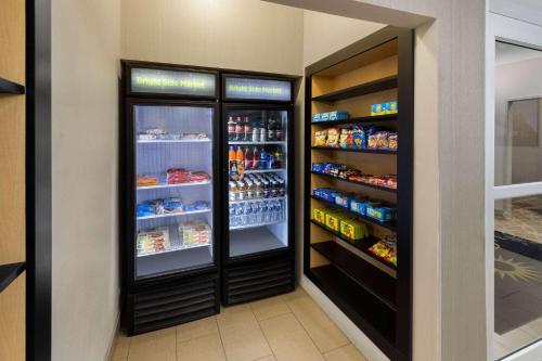 two refrigerators in a store with food and drinks at La Quinta by Wyndham Houma in Houma