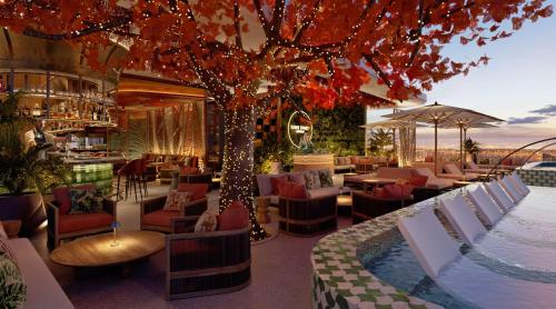 a restaurant with a tree in the middle of it at Conrad Bahrain Financial Harbour in Manama