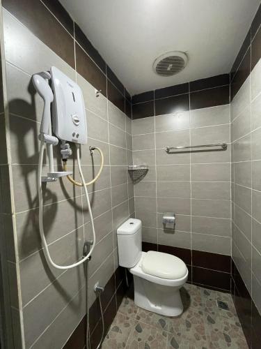 a bathroom with a toilet and a shower in it at Hotel Global Subang in Subang Jaya