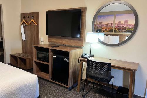 a hotel room with a bed and a television at Days Inn by Wyndham Monroe NC in Monroe