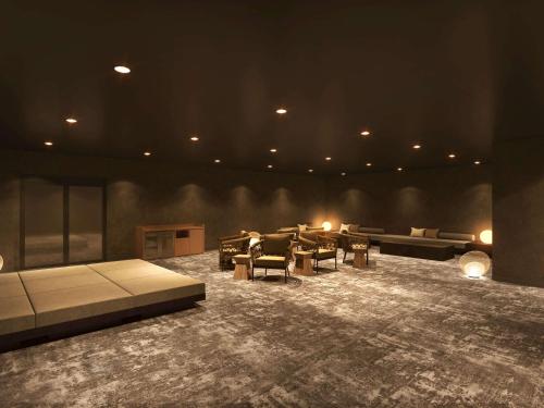 a large living room with couches and tables and lights at Mercure Tottori Daisen Resort & Spa in Daisen