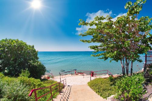 a stairway to the beach with the ocean in the background at Panorama Fort Beach in Sveti Vlas