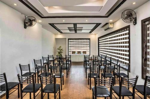 a room with a bunch of chairs in it at Nadhiyoram River Retreat in Cochin