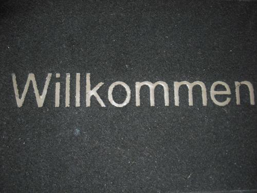 a sign on the street that says willuminati at Haus Gori in Haffkrug