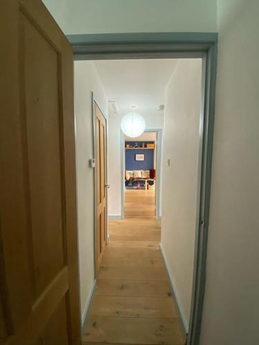 a hallway with a mirror in a room at Bungalow, mountain and sea views parking in Aberdyfi