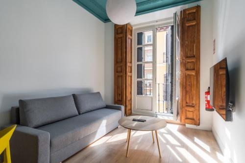 una sala de estar con un sofá y una mesa en Siete Monos, en Madrid