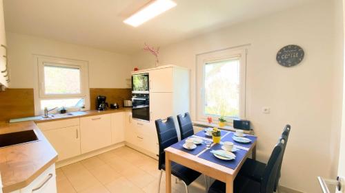 a kitchen with a table and chairs in a room at Haus Hinz in Bermatingen