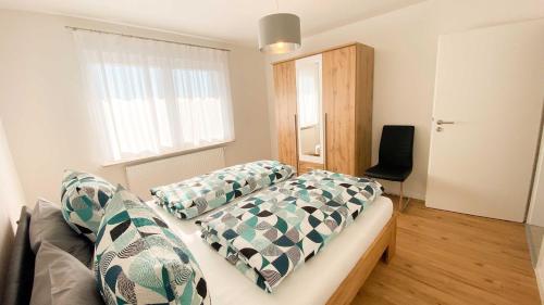 a bedroom with a couch with pillows and a window at Haus Hinz in Bermatingen
