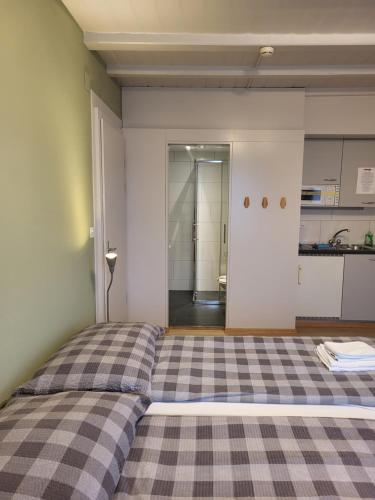 a bedroom with a bed with a checkered floor at Interlaken Apartments in Interlaken