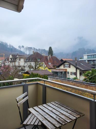 a bench on a balcony with a view of a city at Interlaken Apartments in Interlaken