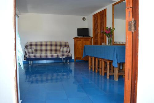 a living room with a table and a chair at Ziloto in Pantelleria