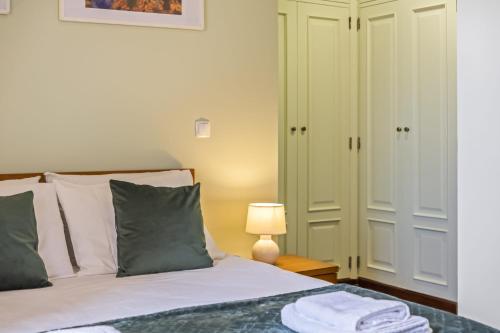 a bedroom with a bed and a lamp on a table at Sea View Apartment in Santa Cruz