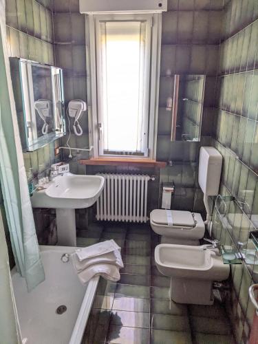 a bathroom with two toilets and a sink at Villa le Ninfee in Pozzolo