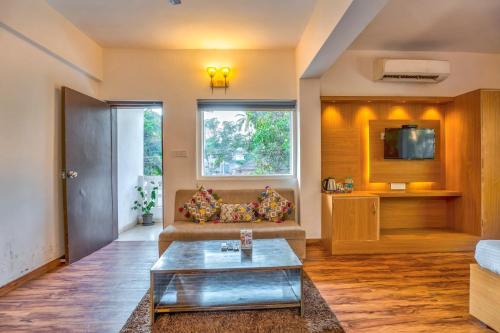 a living room with a couch and a table at The Boho, Vagator Beach Goa Near Thalassa in Anjuna