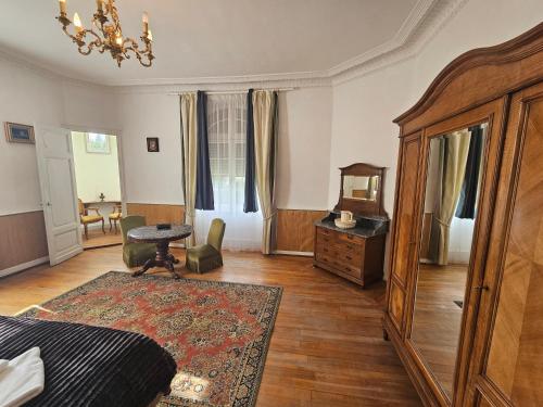 a bedroom with a bed and a table and a dresser at Château de Chazelpaud in Saint-Bard