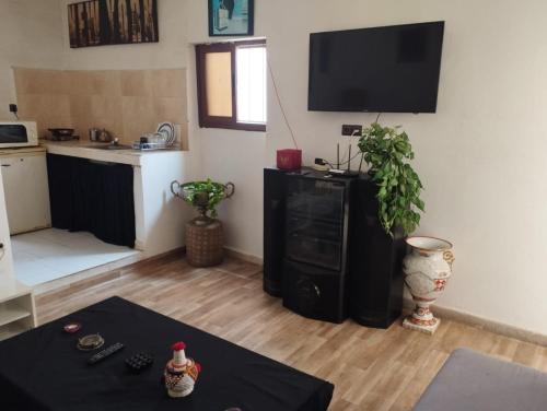 a living room with a flat screen tv on a wall at Studio centre ville Agadir in Agadir