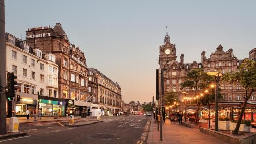 a city street with a clock tower in the distance at Hotel Indigo - Edinburgh - Princes Street by IHG in Edinburgh