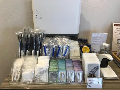 a shelf with many different items on a table at Shizutetsu Hotel Prezio Numazu in Numazu