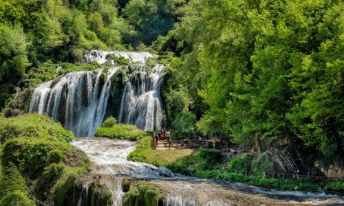 a waterfall in the middle of a forest at Casale Santomanno in Aquasparta