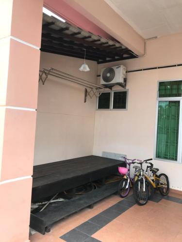a room with two bikes parked next to a wall at Hajjah Homestay Muar in Muar