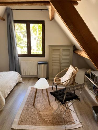 une chambre avec un lit, une table et une chaise dans l'établissement Très belle villa sur les hauteurs de La Baule, à Guérande