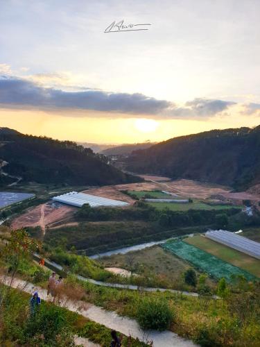 an aerial view of a river with the sunset in the background at Tuyên Chiến Home - Nhà Gỗ in Ấp An Kroët