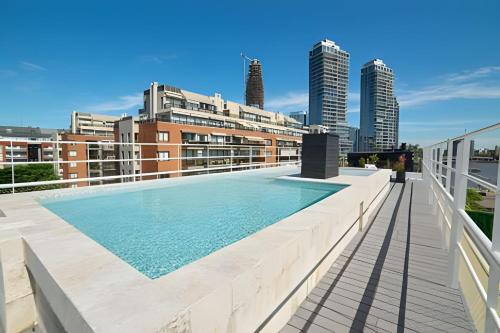 a swimming pool on the roof of a building at STUDIO MODERNO EN PUERTO MADERO FRENTE AL HOTEL MADERO in Buenos Aires