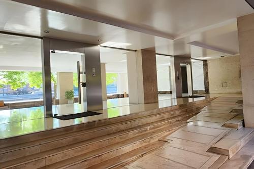 an empty lobby with wooden floors and large windows at STUDIO MODERNO EN PUERTO MADERO FRENTE AL HOTEL MADERO in Buenos Aires