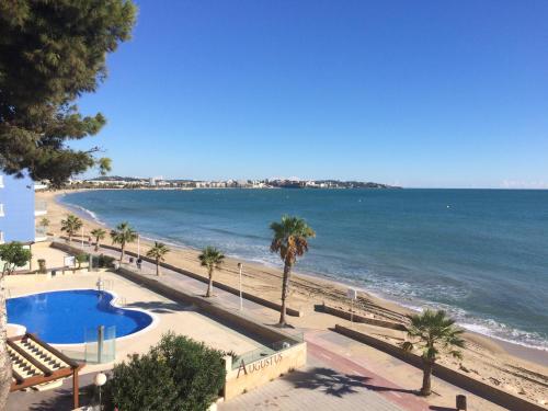 a view of the beach and the ocean from a building at Apartamentos Turísticos Augustus in Cambrils