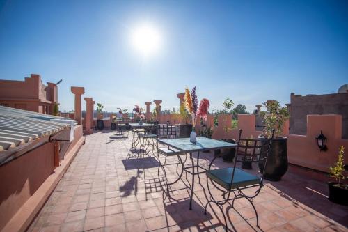 a row of tables and chairs on a patio at Riad Kenza in Marrakech