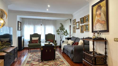 a living room with a couch and a table at Maison Terrasse Doña Irma in Cambados