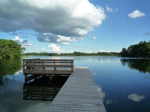 a bench sitting on a dock on a lake at Ferienhaus zum Krakower See in Krakow am See