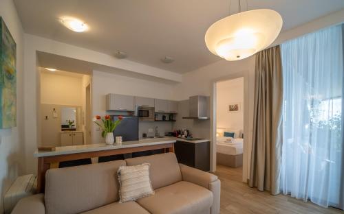a living room with a couch and a kitchen at Amare Luxury Apartments in Budva