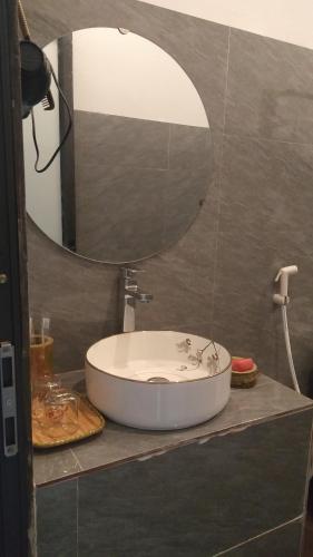 a bathroom with a sink and a mirror at Puluong Aroma in Hương Bá Thước