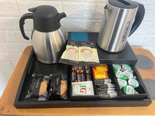 a tray with food and a coffee pot on a table at Evening Tide in Herne Bay