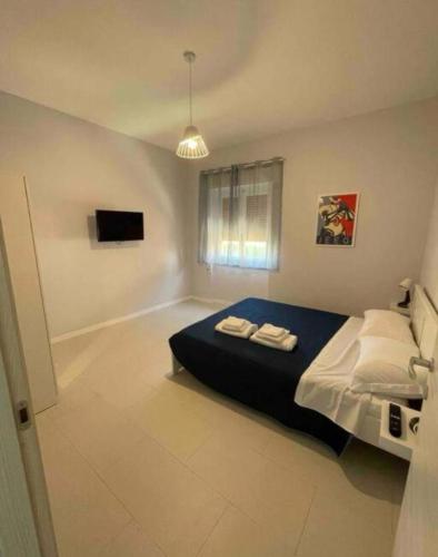 a bedroom with a bed with two towels on it at Les Amis appartamento anzio in Anzio