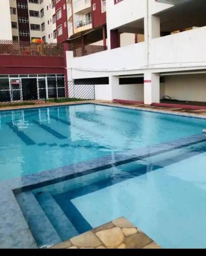 an empty swimming pool in front of a building at Greenzone Apartments in Kiambu