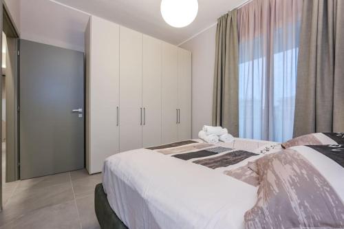 a bedroom with a bed and a large window at LUXURY BASILICA & SEA VIEW 35 - GENOVAINRELAX in Genova