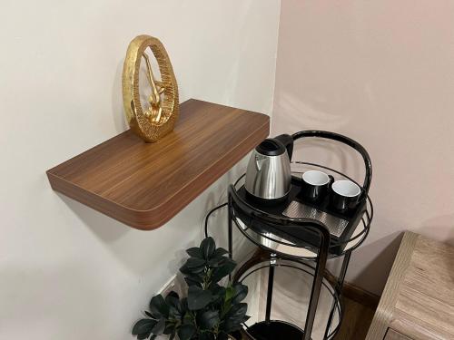 a wooden shelf with a mirror on a wall at Sada Compound (Women Only) سيدات فقط in Riyadh