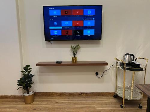 a flat screen tv hanging on a wall at Sada Compound (Women Only) سيدات فقط in Riyadh